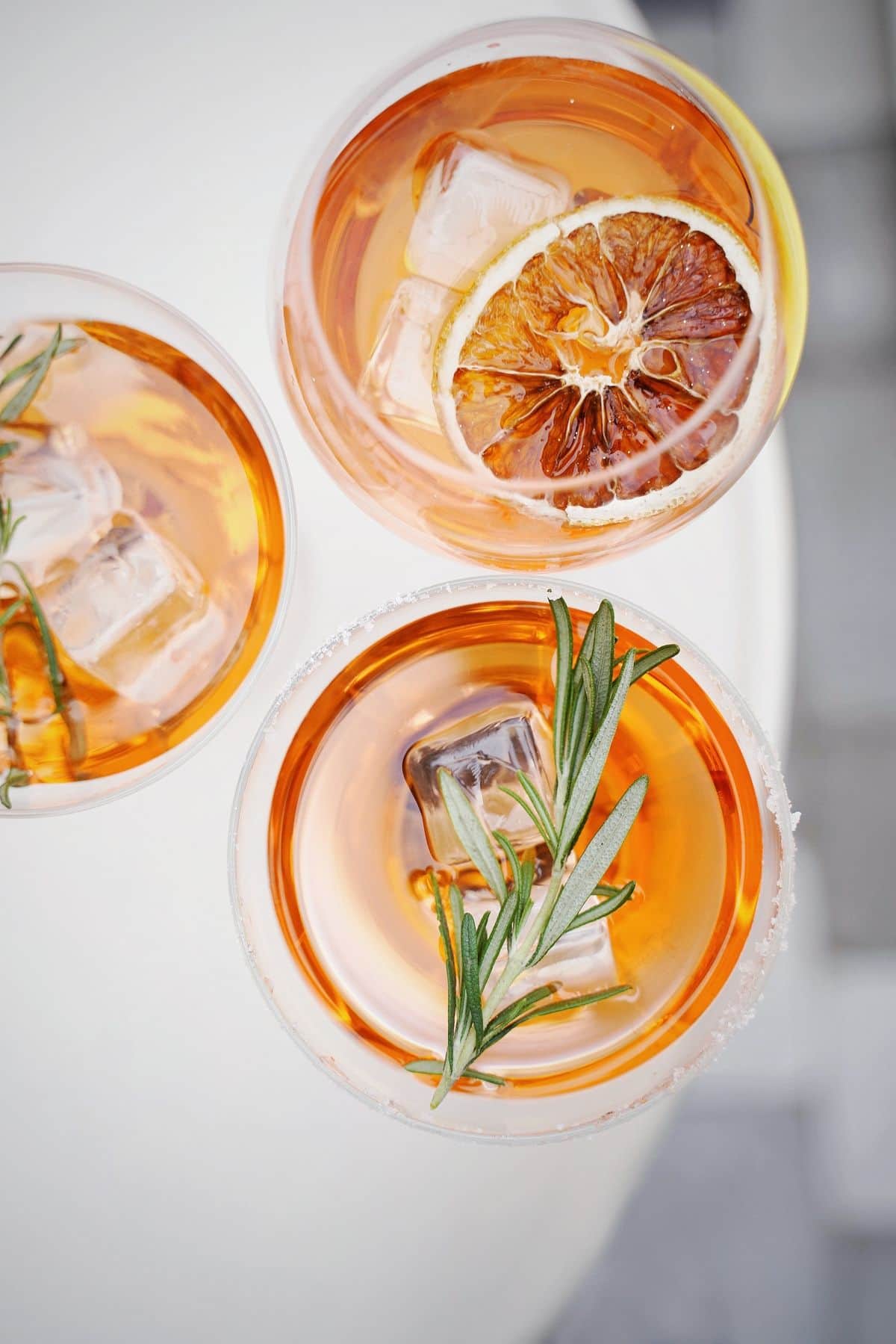 Pink cocktails garnished with dried orange