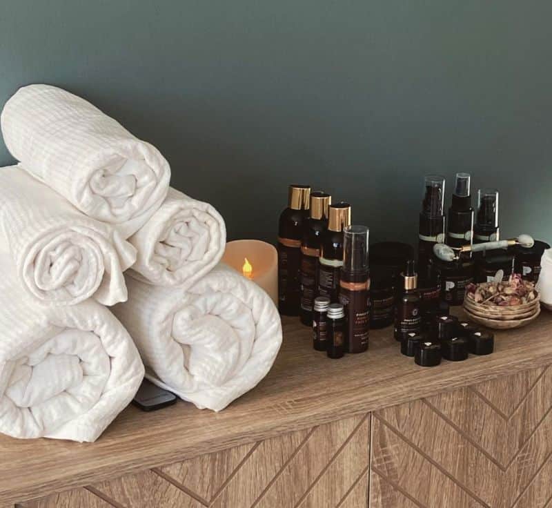 Rolled towels and treatment oils ready for a pamper session