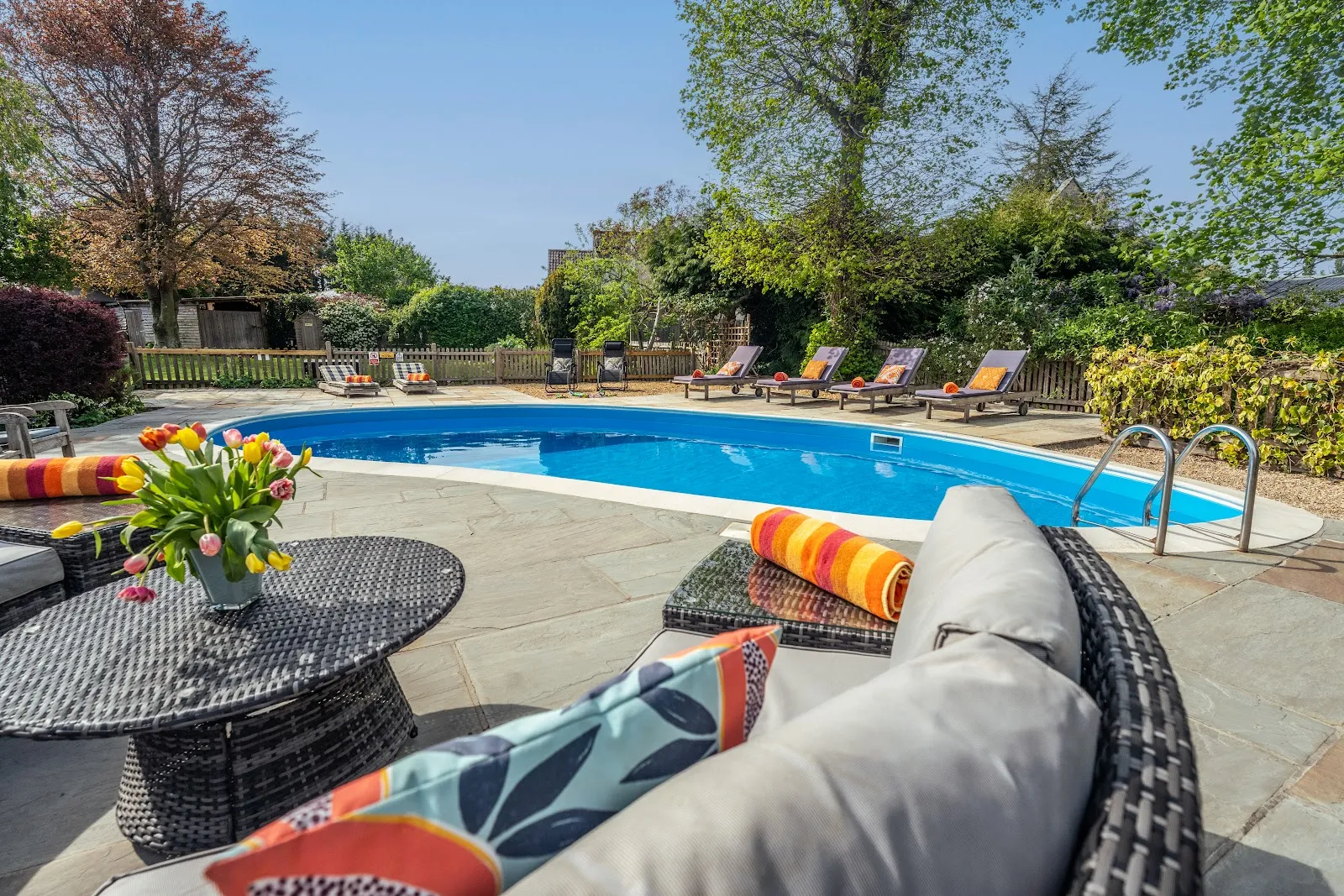 The shared swimming pool and sun loungers at Little Upton, Long Sutton, Somerset, with a private 2.5-hour session for each house daily from May to September