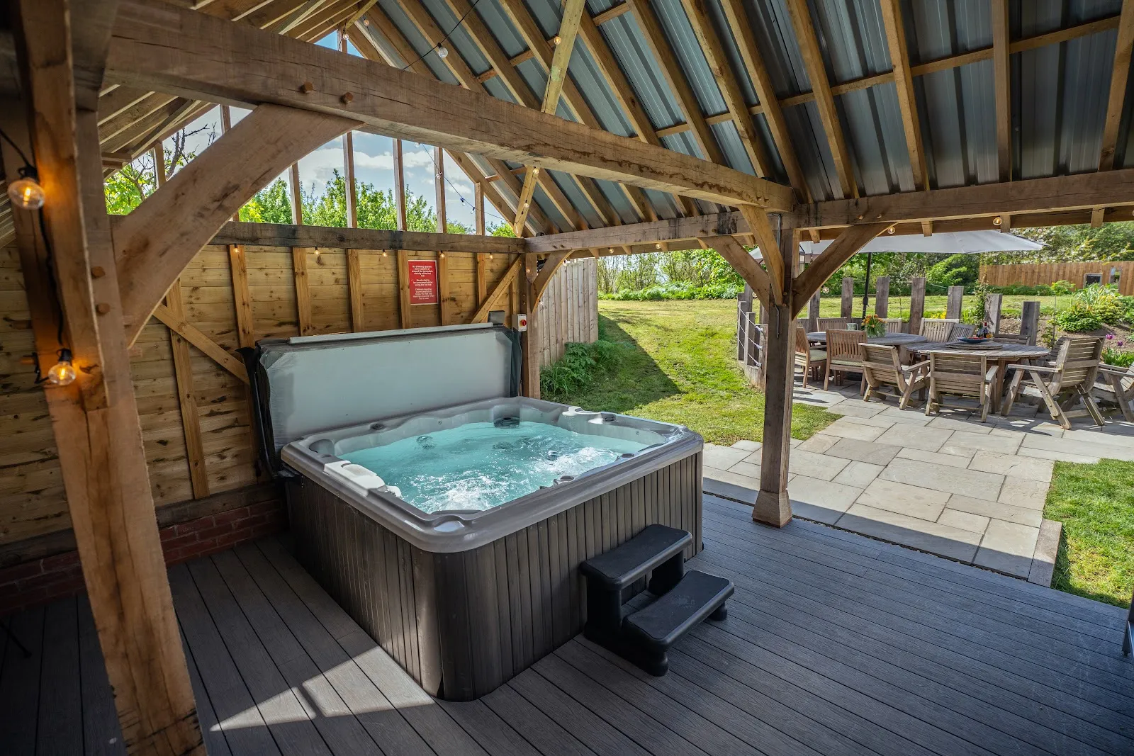 The private outdoor hot tub at Vedalworks, a group holiday house sleeping up to 24 in Long Sutton, Somerset